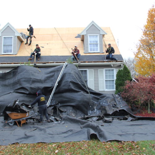 Roofing installation technicians keeping the job clean
